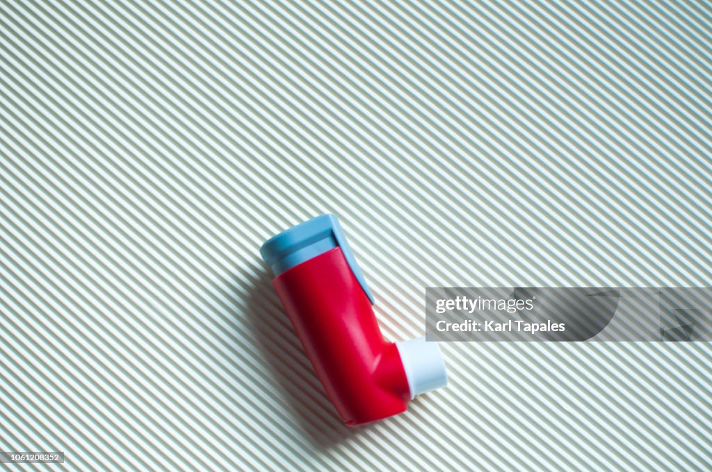A red asthma inhaler device