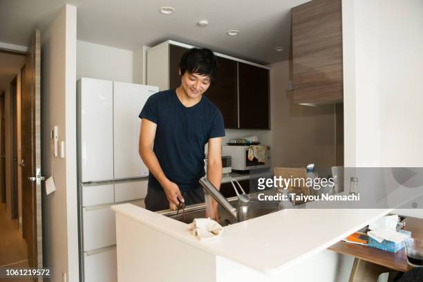 men washing dishes in the kitchen - dirty dishes ストックフォトと画像