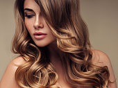 Young beautiful model with long wavy well groomed hair