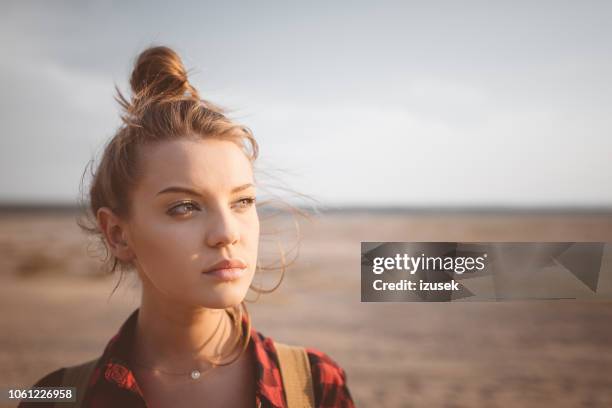 outdoor shot lonely young woman on desert - natural shot female stock pictures, royalty-free photos & images