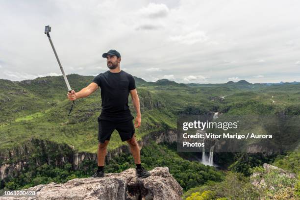 man taking selfie, chapada dos veadeiros, goias, brazil - selfie stick stock pictures, royalty-free photos & images