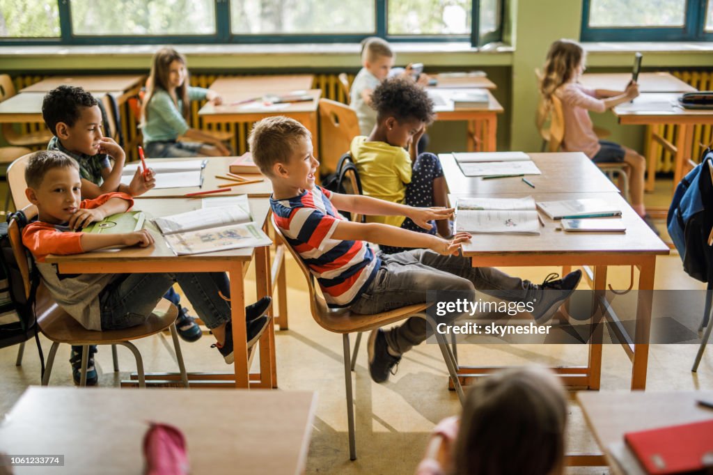 Kid Rocking In Chair Happy Schoolboy Swinging On A Chair During A Class At Elementary School ...