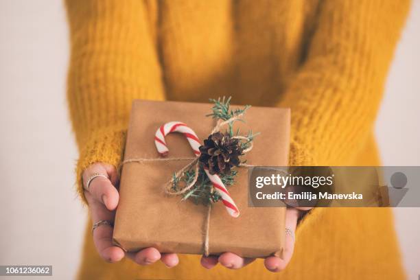 close up of a woman holding gifts - wrapping arm stock pictures, royalty-free photos & images