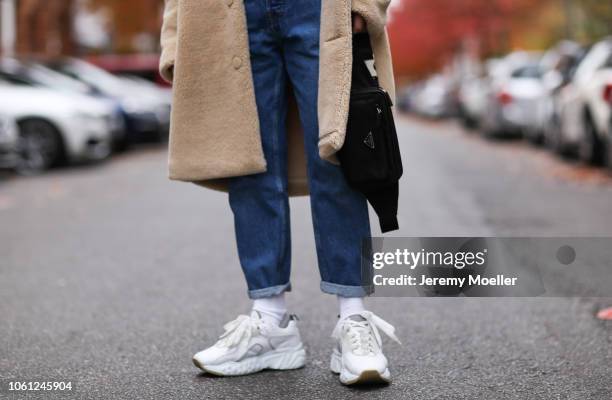 Erik Scholz wearing Chanel suspenders, Topman teddy coat, Acne Studios sneaker and a Acne Studios shirt on October 28, 2018 in Berlin, Germany.