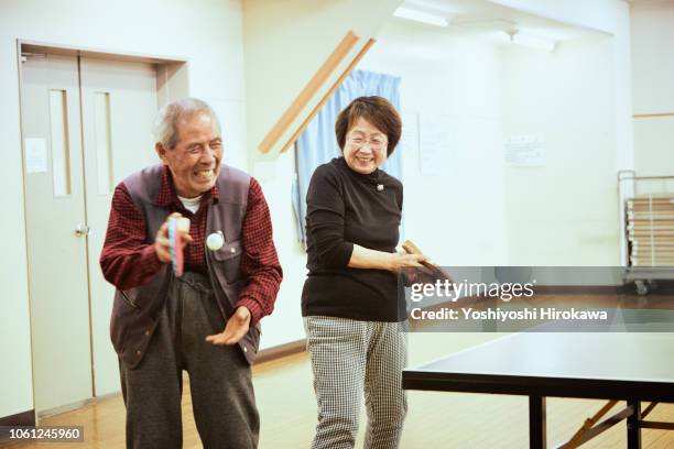 senior playing table tennis - active retirement community stock pictures, royalty-free photos & images