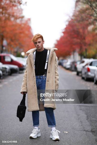 Erik Scholz wearing Chanel suspenders, Topman teddy coat, Acne Studios sneaker and a Acne Studios shirt on October 28, 2018 in Berlin, Germany.