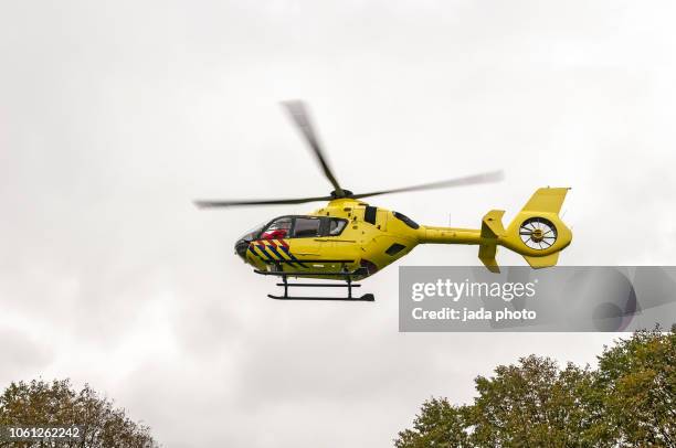 yellow trauma helicopter - north holland stock-fotos und bilder