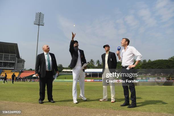 Sri Lanka captain Suranga Lakmal tosses the coin as Joe Root looks on during Day One of the Second Test match between Sri Lanka and England at...