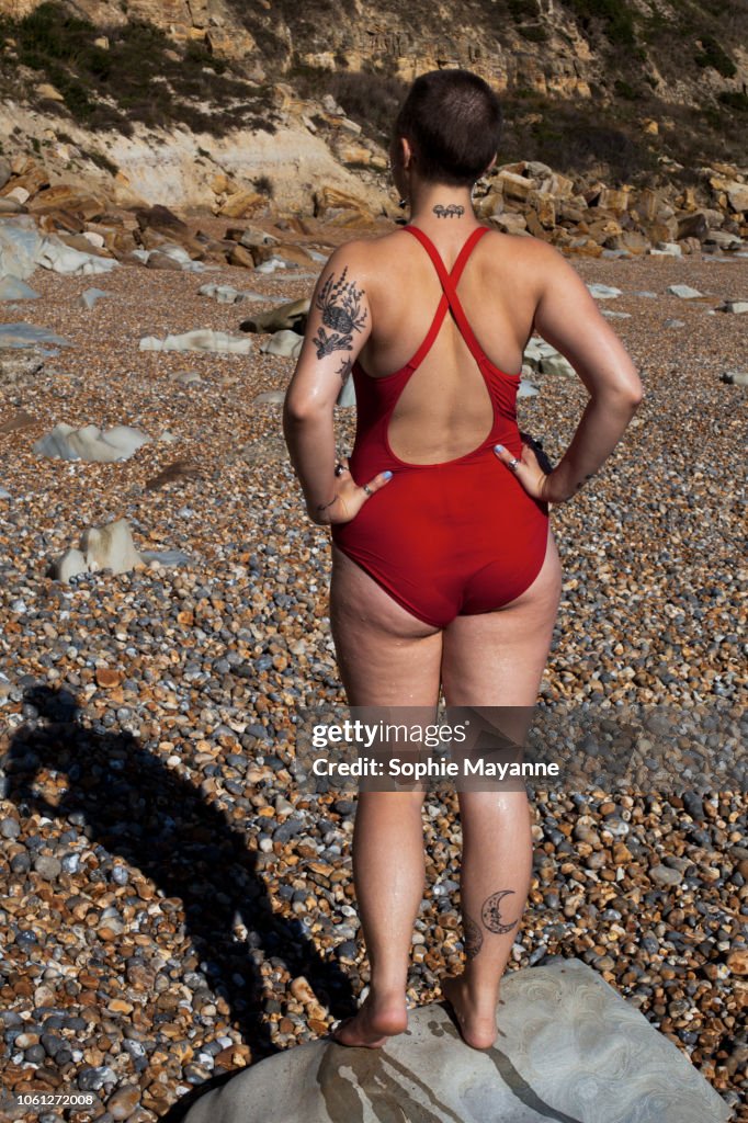 A young woman stood on a rock at the beach