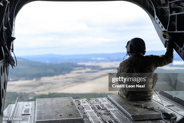 Member of the US Army aircrew surveys the Norwegian countryside from the rear of a US Army Chinook helicopter during pre-exercise integration...