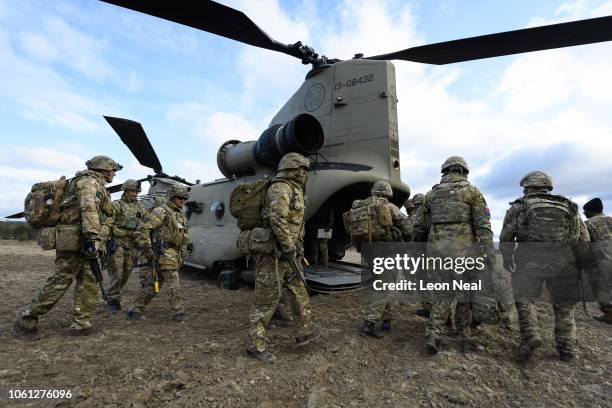 Members of the British Army Royal Irish Battle Group prepare to board a US Army Chinook helicopter to fly to recce a number of locations during...