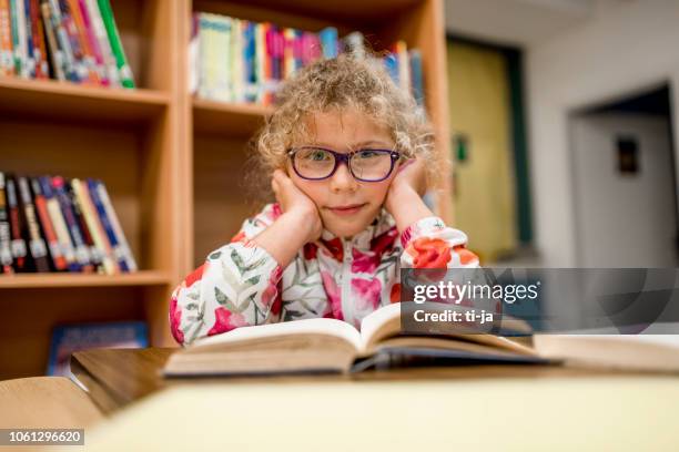 little girl in a library - ljubljana library stock pictures, royalty-free photos & images