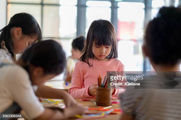 young group of students in an arts and crafts class - preschool art stock pictures, royalty-free photos & images