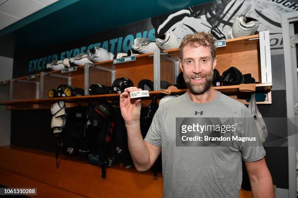 Joe Thornton of the San Jose Sharks holding up the puck from his 400th career goal which was scored against the Nashville Predators at SAP Center on...