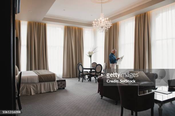 mature man in hotel room - en suite stock pictures, royalty-free photos & images