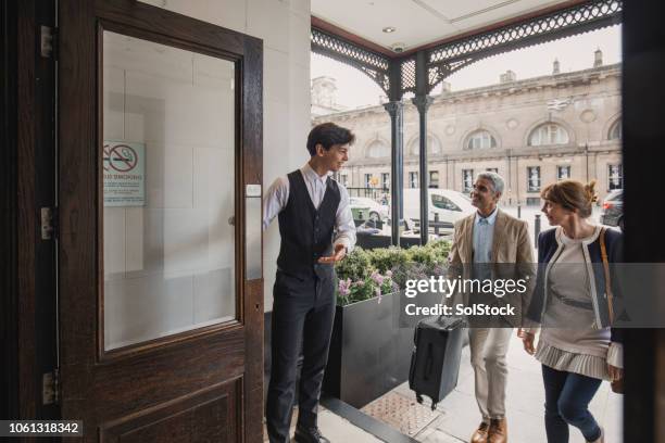 welcome to our hotel - bellhop stock pictures, royalty-free photos & images