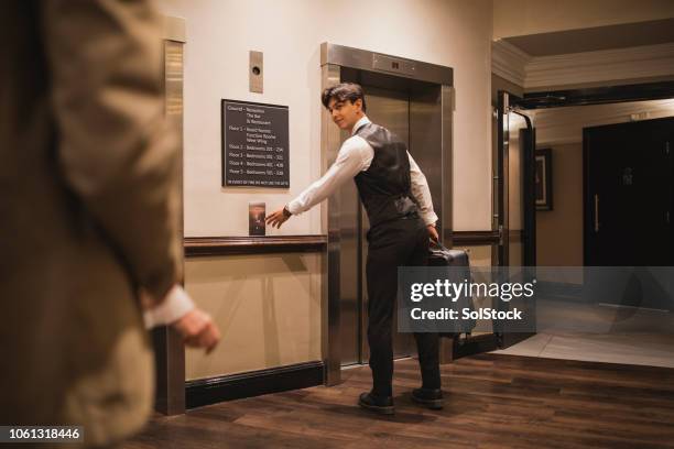 please follow me to your room - door attendant stock pictures, royalty-free photos & images