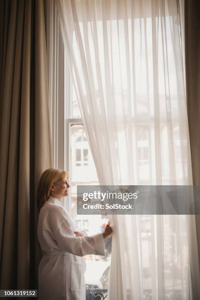 woman enjoying hotel room view - women of penthouse stock pictures, royalty-free photos & images