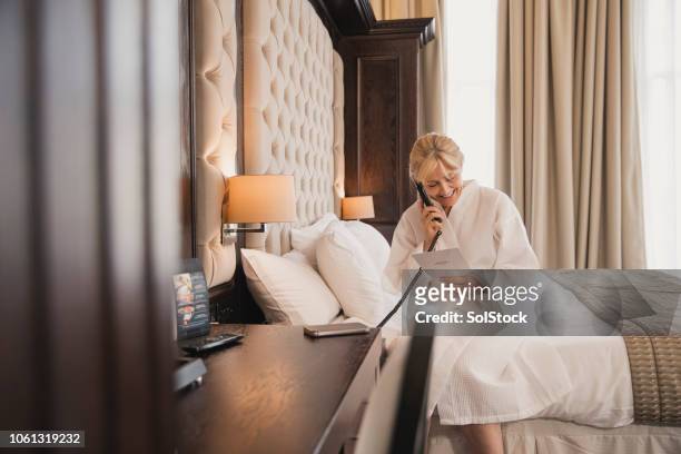 ordering room service - luxury hotel room stock pictures, royalty-free photos & images