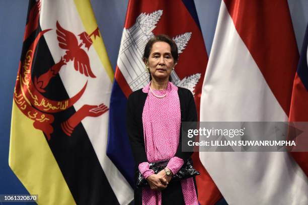 Myanmar State Counsellor Aung San Suu Kyi arrives on stage to pose for a group photo before the start of the ASEAN-Japan summit on the sidelines of...