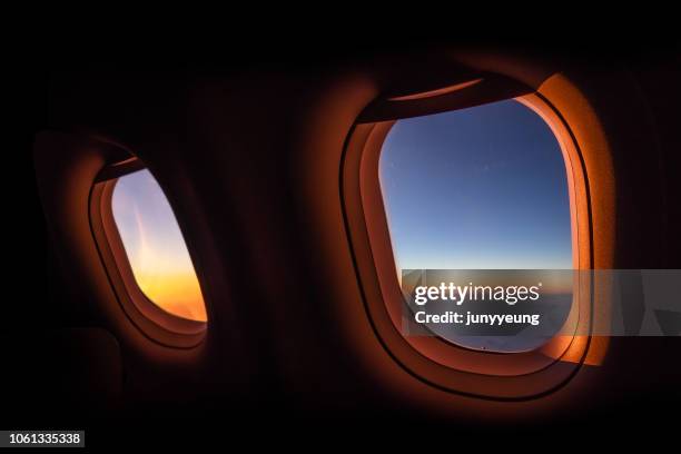 sunrise view from airplane windows - 飛行機　窓 ストックフォトと画像