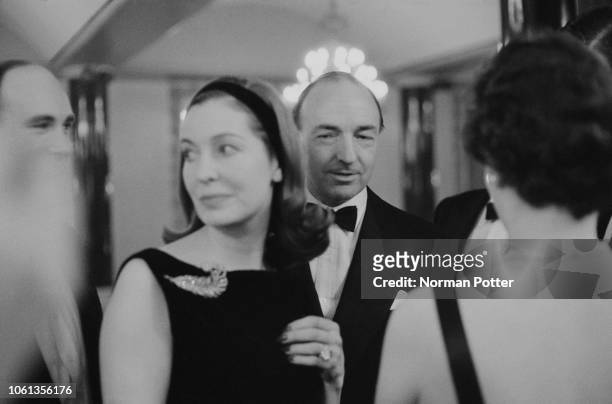 British politician John Profumo attending a party with his wife, Irish actress Valerie Hobson , UK, 22nd March 1963.