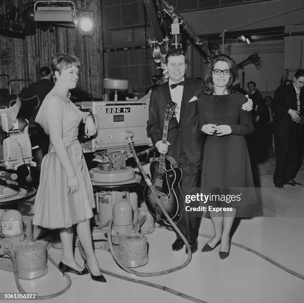 Greek singer Nana Mouskouri with Danish jazz and pop guitarist Jørgen Ingmann and his wife Grethe at the 1963 Eurovision Song Contest, BBC Television...