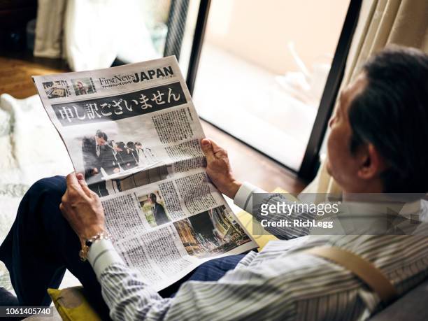 japanese man with newspaper - press conference room stock pictures, royalty-free photos & images