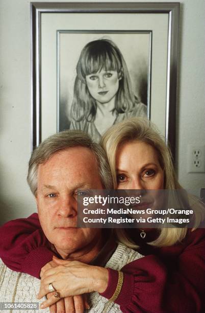 Jack and Genelle Reilley pose in front of a portrait of their daughter Robbin Brandley on January 13, 1994. Brandley who was stabbed in Saddleback...