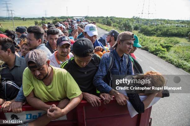 Group of Central Americans travel on a trailer to Juchitan, the next destination of the caravan on October 30, 2018 in Juchitan, Mexico. The caravan...