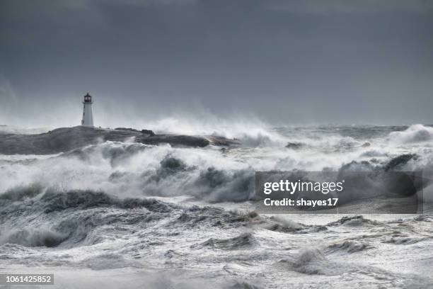 turbulent ocean lighthouse - storm lighthouse stock pictures, royalty-free photos & images