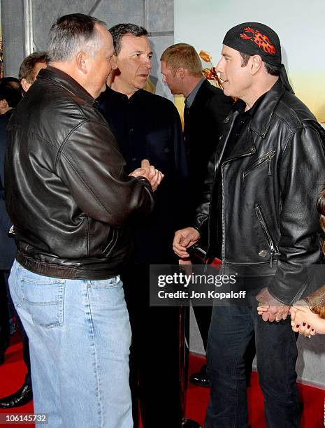 Disney's Dick Cook, Disney's Robert A. Iger and John Travolta