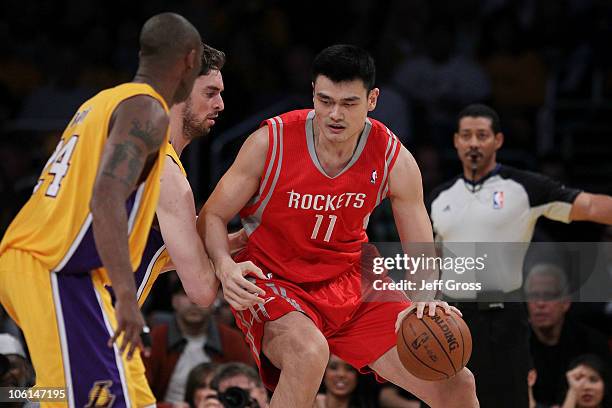 Pau Gasol of the Los Angeles Lakers defends as Yao Ming of the Houston Rockets controls the ball during their NBA game at Staples Center on October...