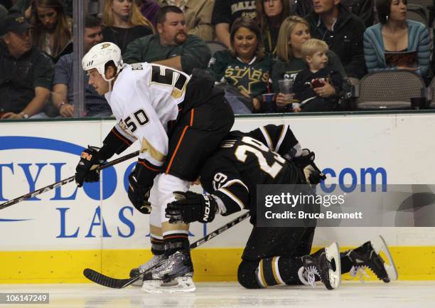 Steve Ott of the Dallas Stars is tripped up and falls into the back of Troy Brodie of the Anaheim Ducks at the American Airlines Center on October...