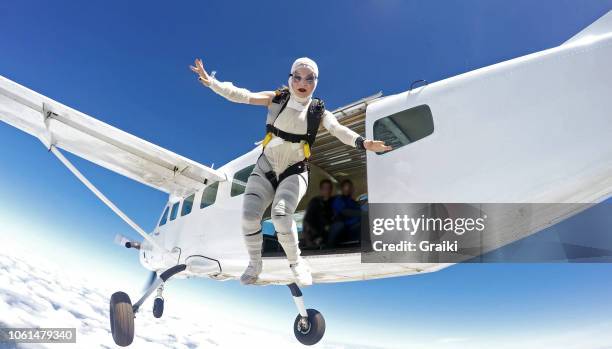 woman parachutist costumed mummy jumping out of plane - skydiving stock pictures, royalty-free photos & images