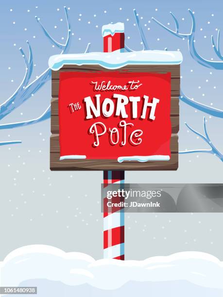 north pole wooden winter sign with handwriting or hand lettered text - wood pole stock illustrations