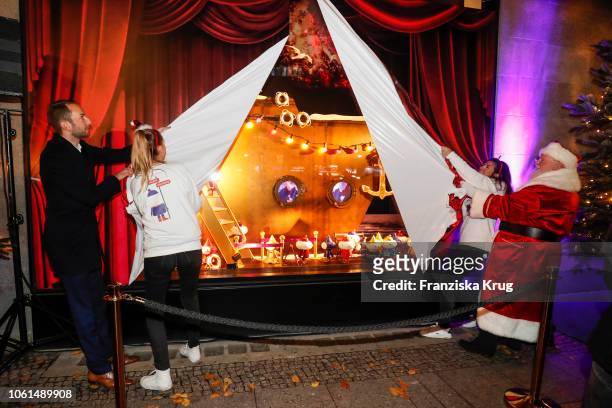 Store Manager KaDeWe Timo Weber, Santa Claus and two hostesses during the Christmas gallery opening at KaDeWe on November 14, 2018 in Berlin, Germany.