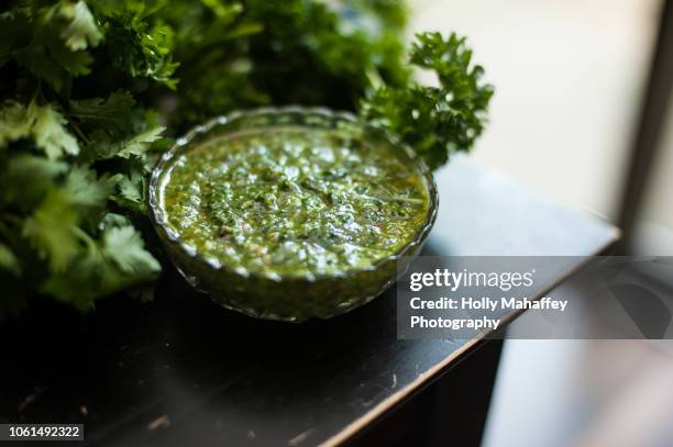 bowl of chimichurri and greens - chimichurri stock pictures, royalty-free photos & images