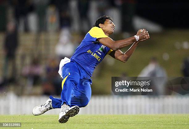 Suraj Randiv of Sri Lanka takes a catch to dismiss Phil Hughes during the Twenty20 match between the New South Wales Blues and Sri Lanka at Blacktown...