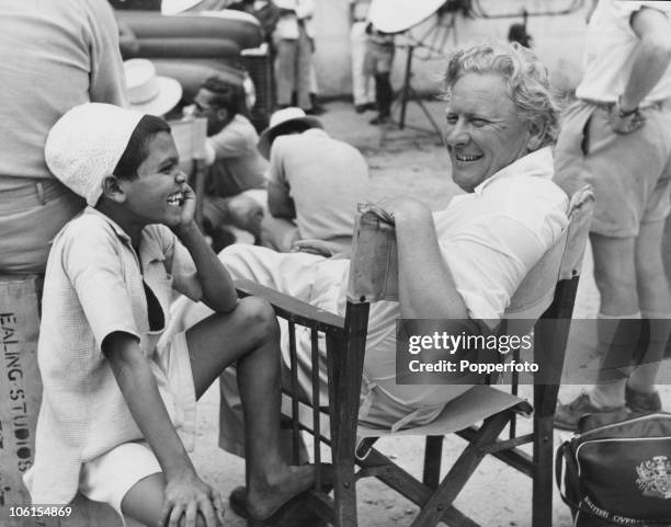 Director Harry Watt chats with local boy Juma, whilst shooting the film 'West of Zanzibar' on location in East Africa. Juma has a role in the film,...