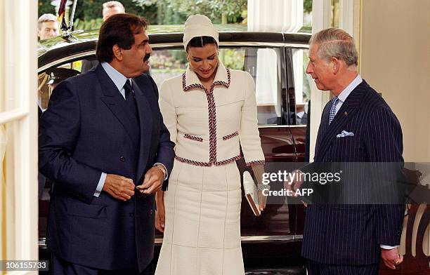 Britain's Prince Charles , welcomes Qatar's emir, Sheikh Hamad bin Khalifa al-Thani , and his wife Sheikha Mozah , to Clarence House in central...