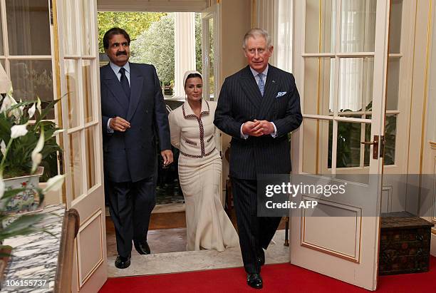 Britain's Prince Charles , welcomes Qatar's emir, Sheikh Hamad bin Khalifa al-Thani , and his wife Sheikha Mozah , to Clarence House in central...