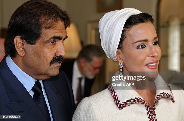 Qatar's emir, Sheikh Hamad bin Khalifa al-Thani and his wife Sheikha Mozah, talk to students during their visit to Clarence House in central London...