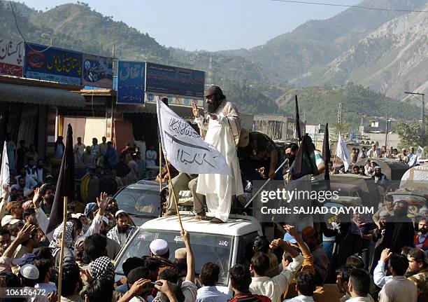 Syed Salahuddin, supreme commander of Hizbul Mujhideen and chairman of the United Jihad Council, stands on a vehicle during a rally in Muzaffarabad...