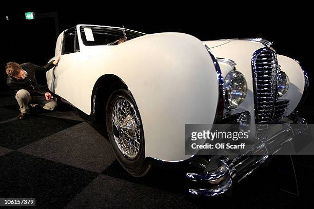 Man takes a photograph of a 1948 Delahaye 175S Coupe de Ville Aerodynamic Body, with an estimated sale price of 120,000 GBP, prior to the...