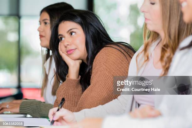 bored college student listens to guest speaker or lecturer - bored audience stock pictures, royalty-free photos & images