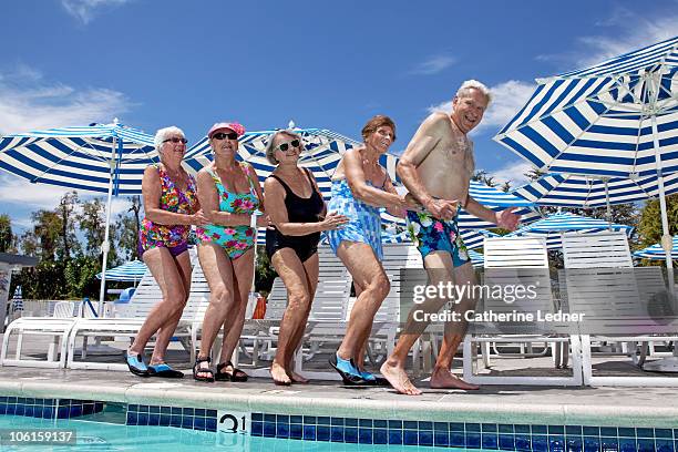 group of seniors dancing by the pool - young at heart stock pictures, royalty-free photos & images