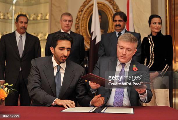 British Minister for Business and Enterprise, Mark Prisk and Qatar's Minister of Finance Yousef Hussain Kamal sign a tade agreement as Qatar's Prime...