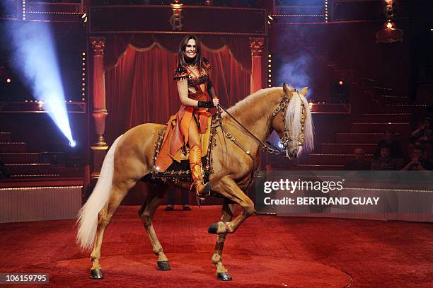 Regina Bouglione performs with her horse during the "Prestige" Bouglione circus show at the Cirque d'Hiver in Paris on October 26, 2010. AFP PHOTO /...
