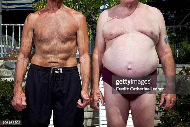 close up of senior men in swimming suits - man wearing speedo stock-fotos und bilder